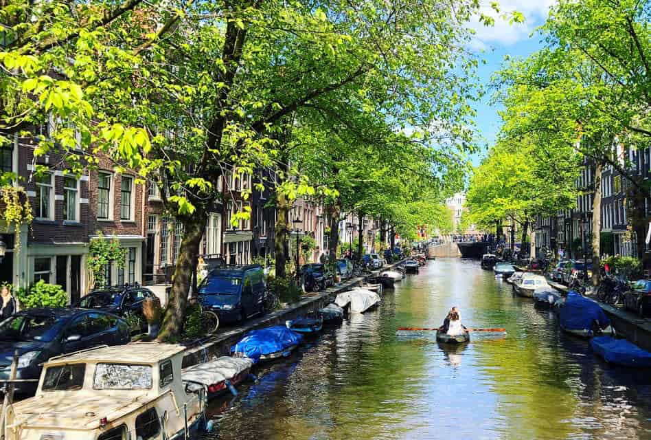 small boat on amsterdam canal