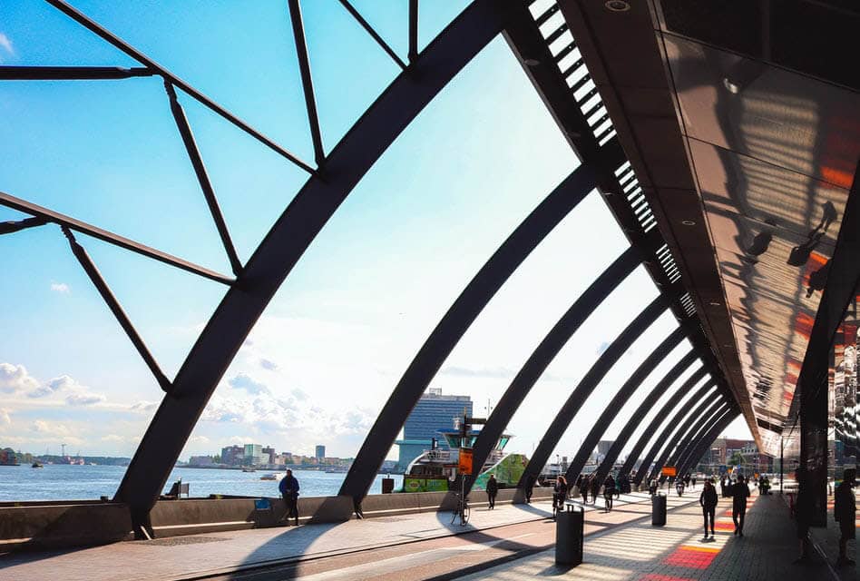 glass curved bridge in amsterdam