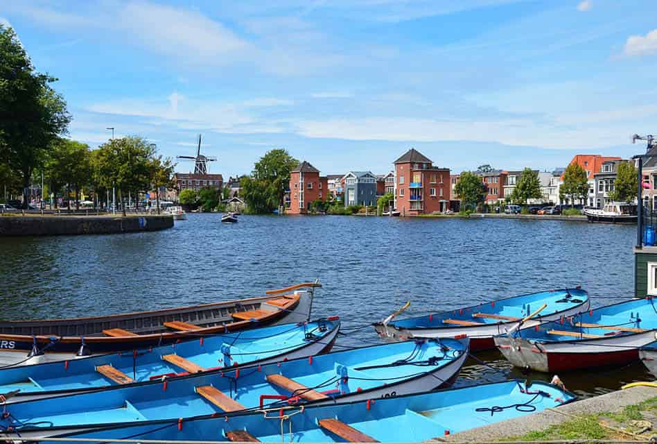 view across boats to windmill in haarlem