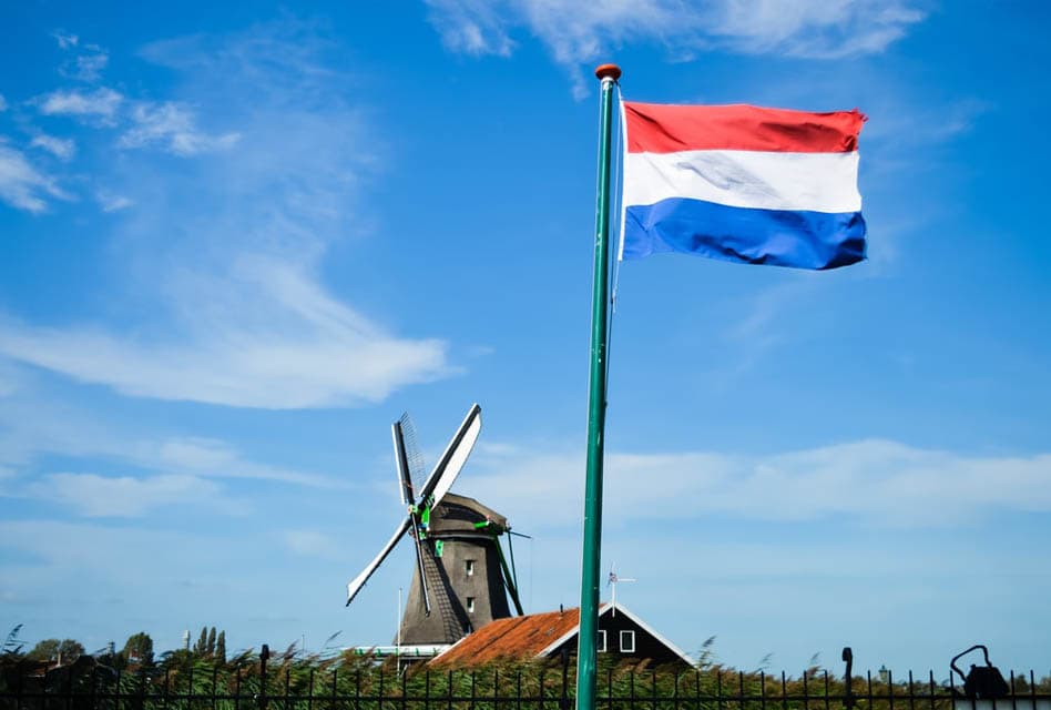 zaanse schans windmill dutch flag in foreground