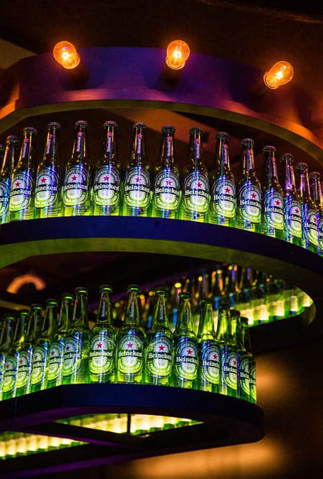 heineken bottles at a bar