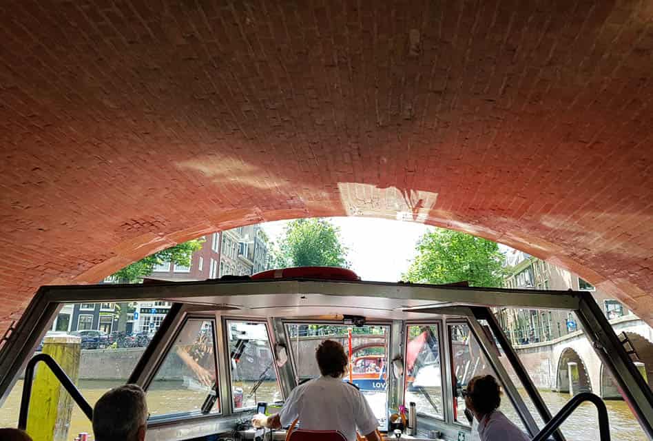 amsterdam cruise under canal bridge